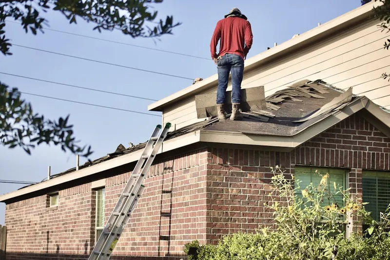 Professional roofer working on a residential roof in Lake Cove Village
